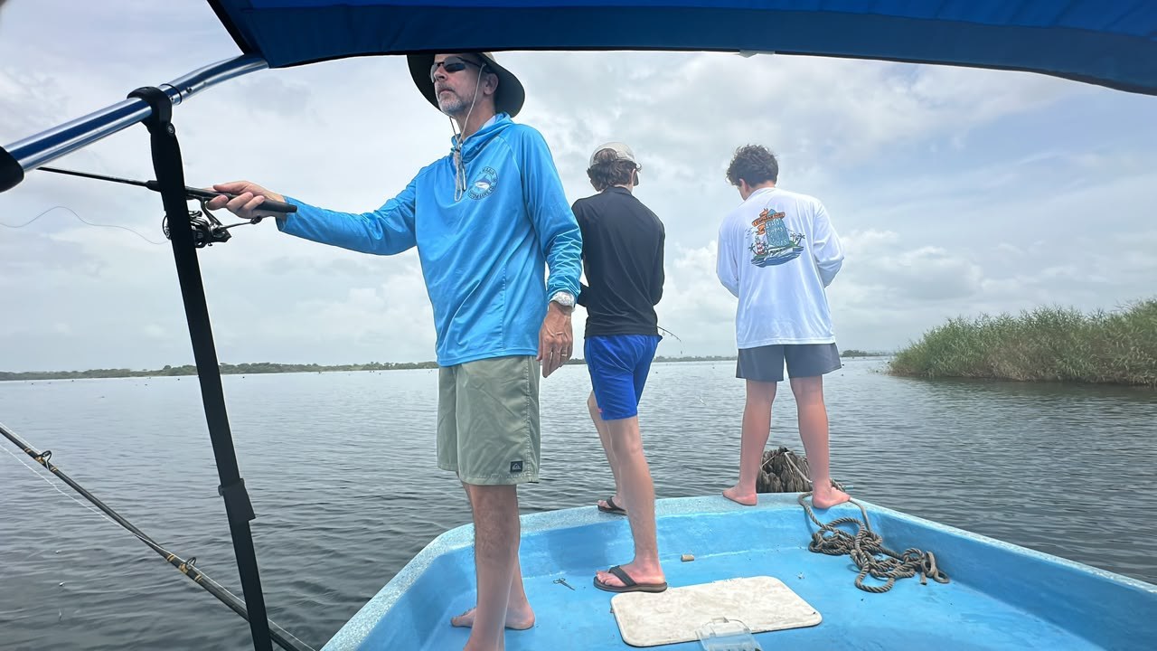 Three anglers casting from Panalake fishing boat on Gatun Lake
