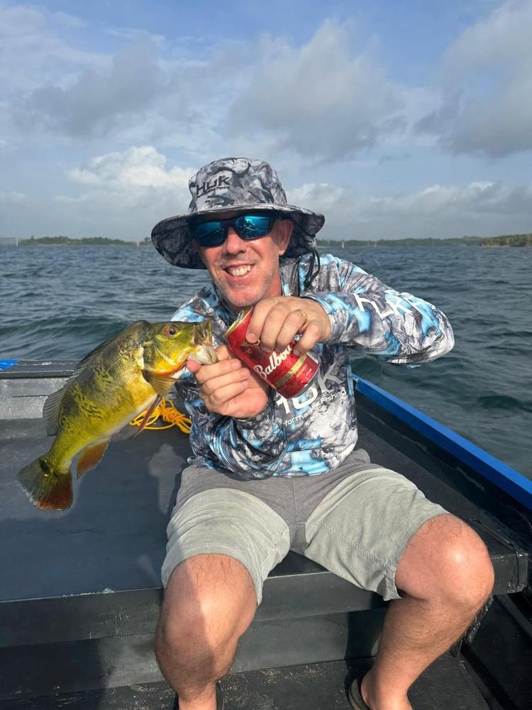 Angler netting a fish at dawn on Gatun Lake